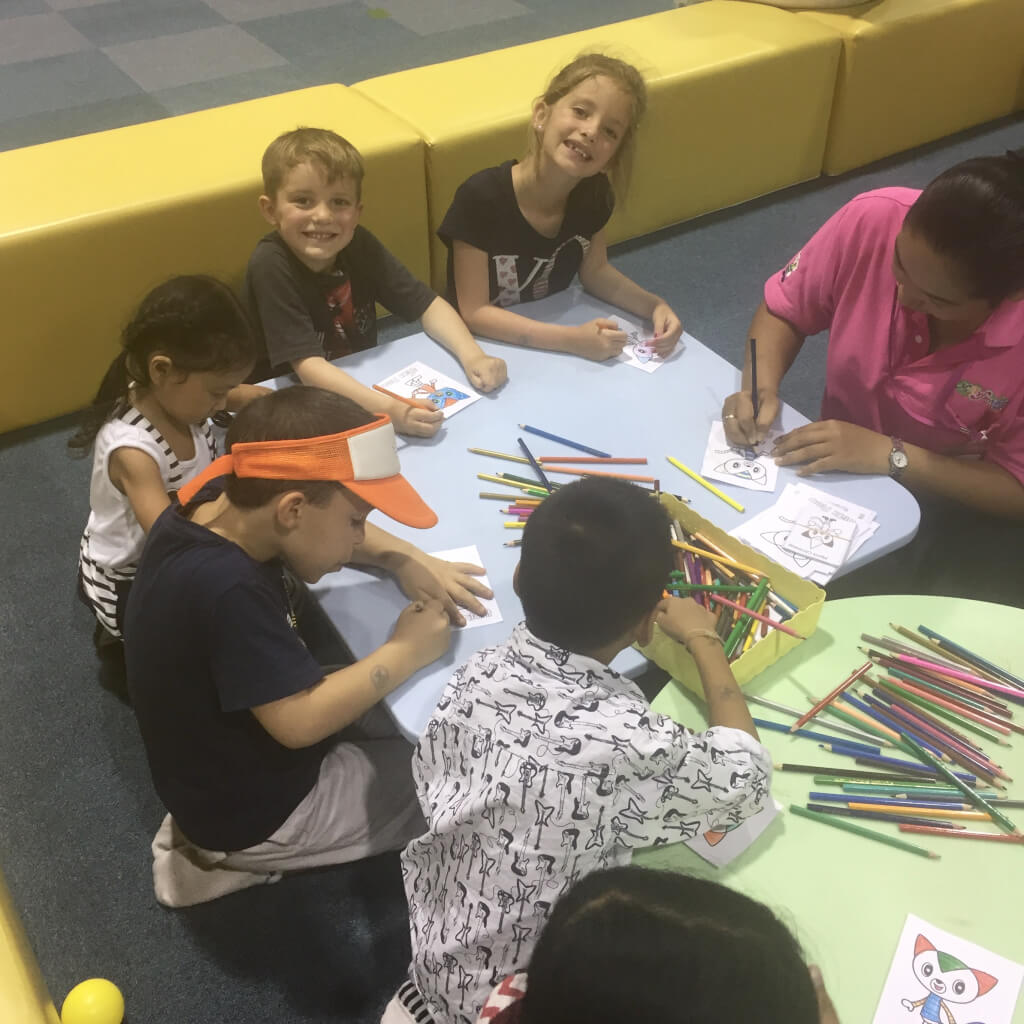 Liberty and Justice coloring with a group of kids in Thailand.
